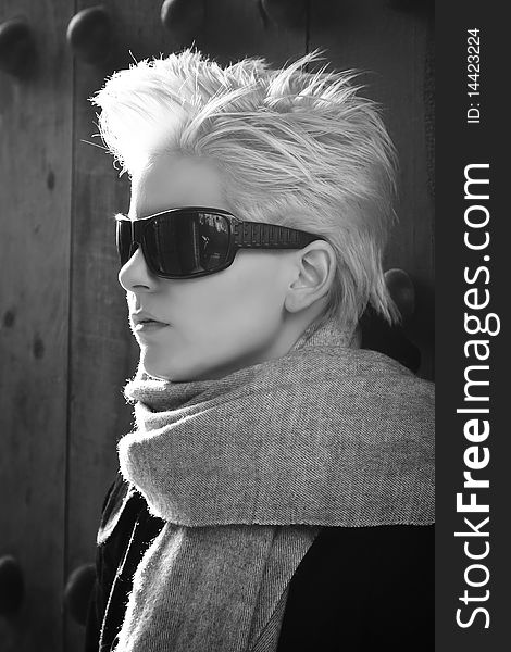 Young blond woman in winter fashion wearing sunglasses. Young blond woman in winter fashion wearing sunglasses.