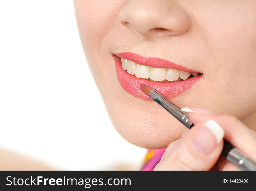 Applying liquid glossy lipstick using special brush