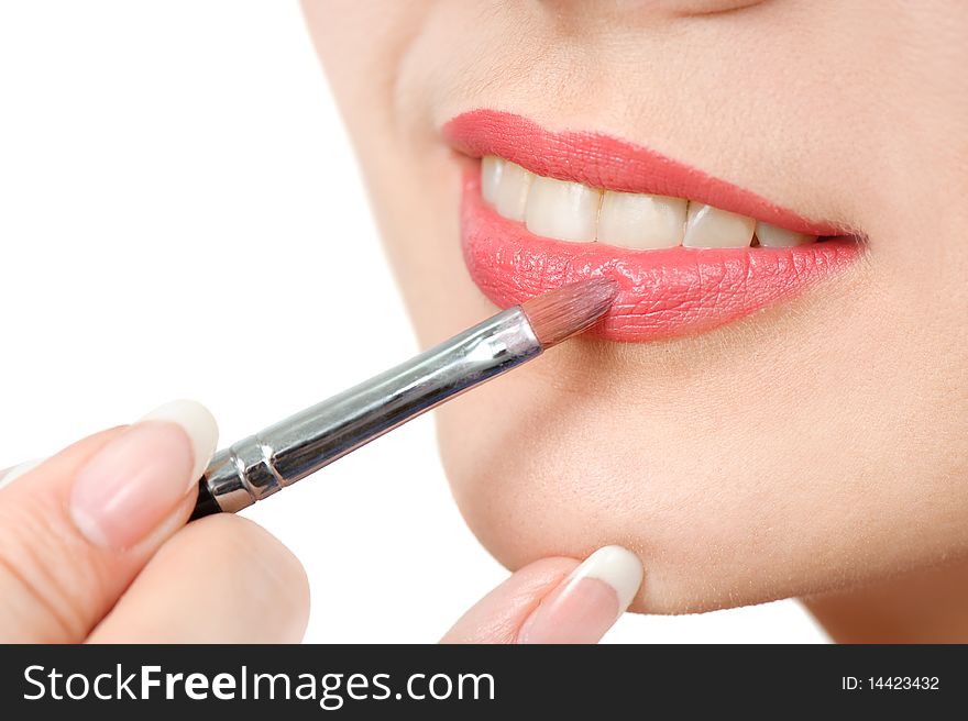 Applying liquid glossy lipstick using special brush