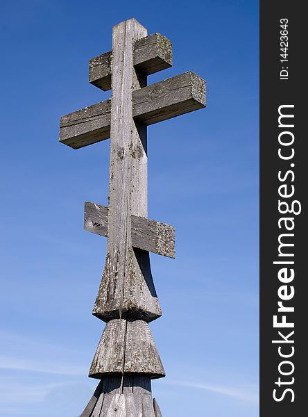 Wooden church cross on a blue sky background