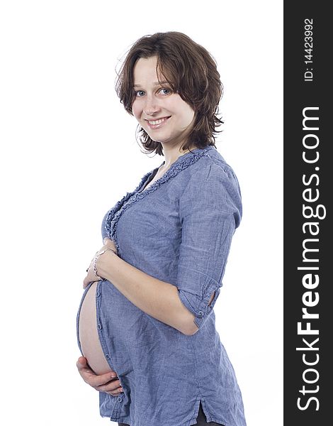 Beautiful pregnant young woman smiling, in a shirt. Beautiful pregnant young woman smiling, in a shirt