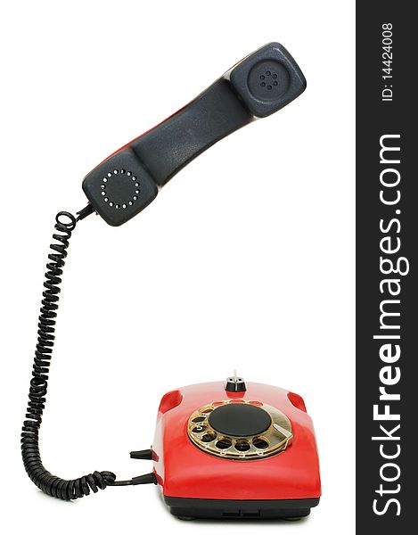 Red old telephone isolated over white