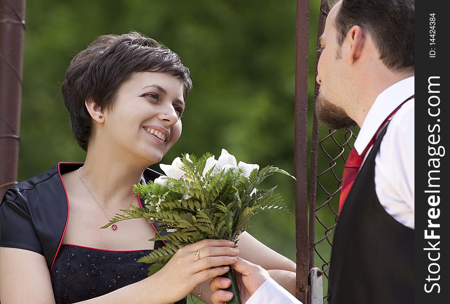 Man offering flowers to young beautiful woman. Man offering flowers to young beautiful woman