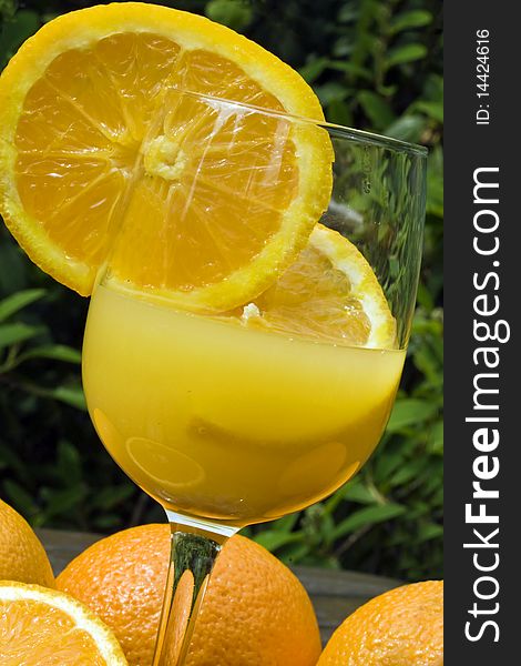 A close-up of a glass of fresh  squeezed orange juice outdoors. A close-up of a glass of fresh  squeezed orange juice outdoors