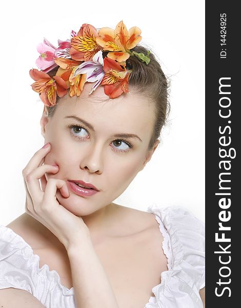 Young beautful woman in floral wreath over white