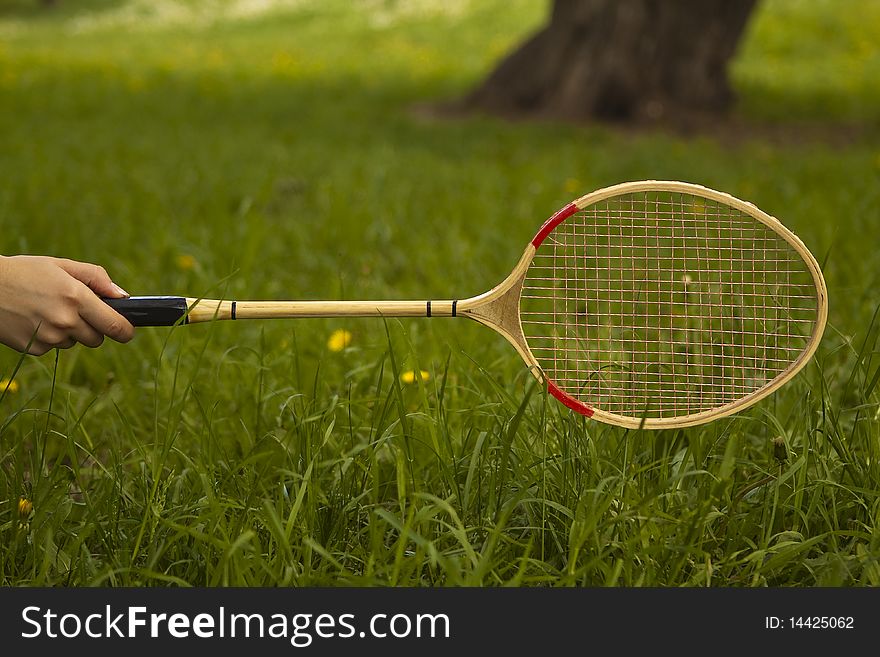 A human hand holding a tennis racket