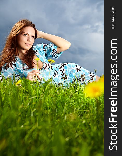 Beautiful young woman on field in summer