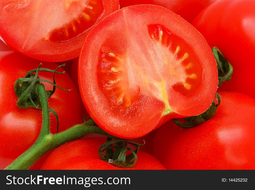 Ripe red  tomatoes on a green twig