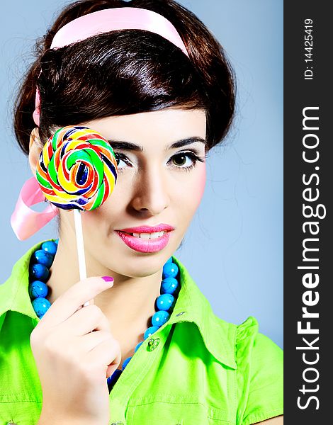 Portrait of a beautiful girl with big lollipop. Retro style. Portrait of a beautiful girl with big lollipop. Retro style.