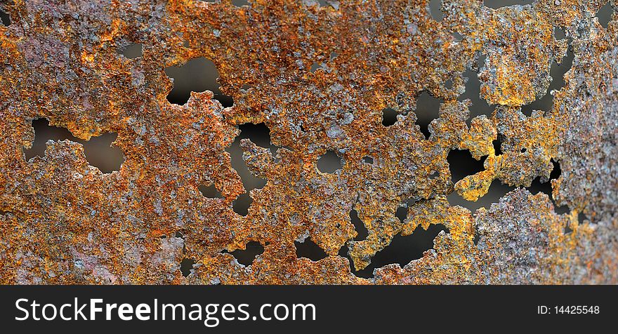 Rust texture originally from an old burn barrel. gritty brown and orange colors with holes. Rust texture originally from an old burn barrel. gritty brown and orange colors with holes.