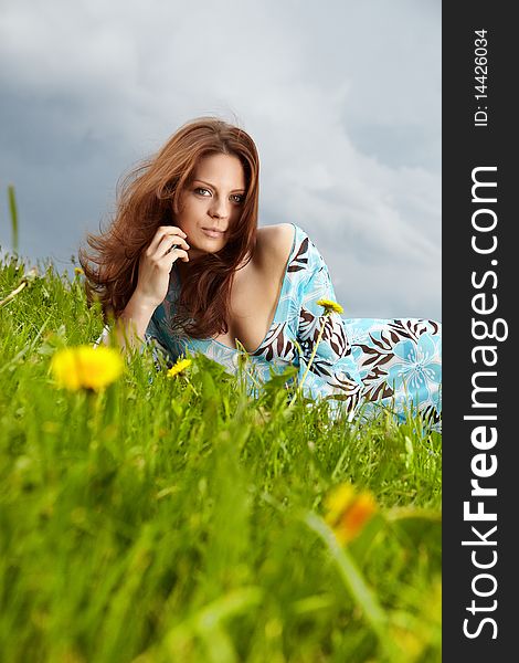 Beautiful young woman on field in summer