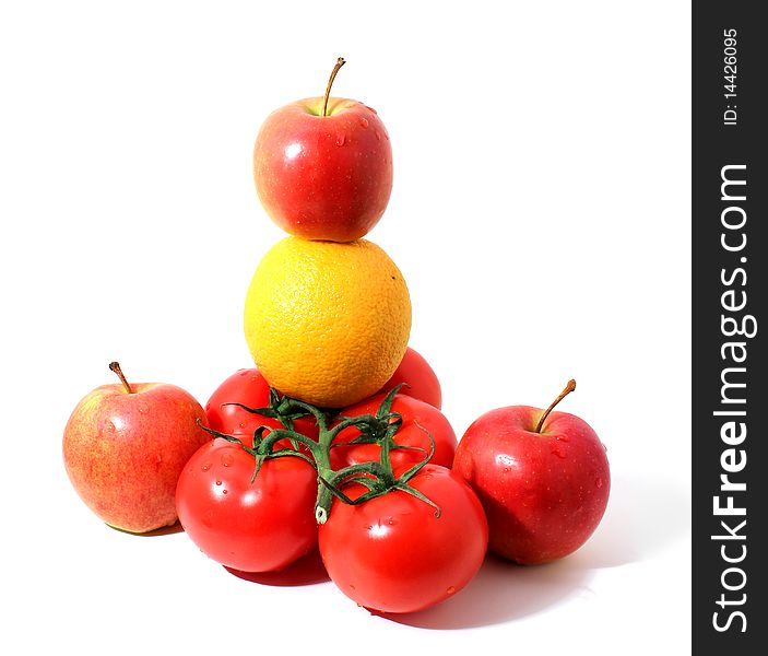 Branch of tomatos, red apples and orange with shadow isolated over white