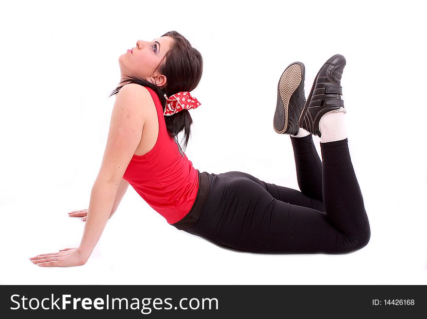 Pretty young girl in the gymnastic pose isolated on white background