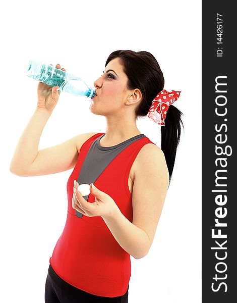 Young woman drinking water from plastic bottle after fitness isolated on white background