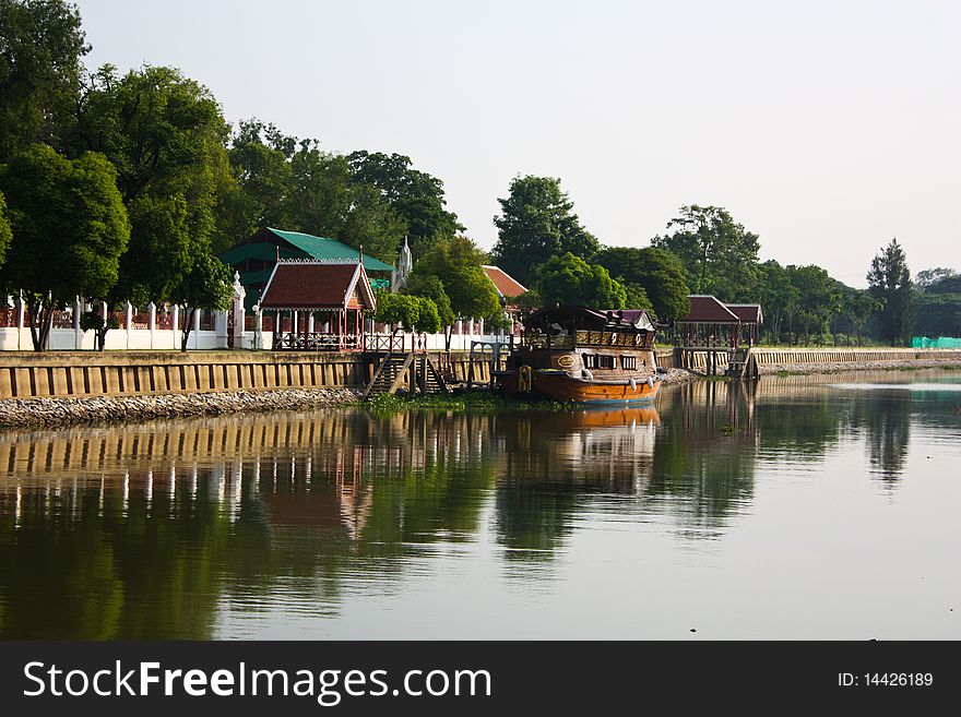 Refection of very old style transport ship in the river in Thailand