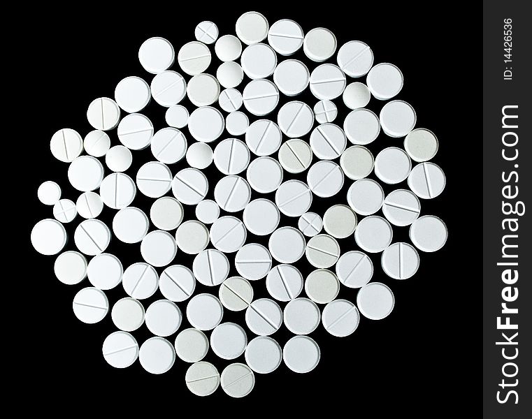 White Pills On The Black Background. Top View