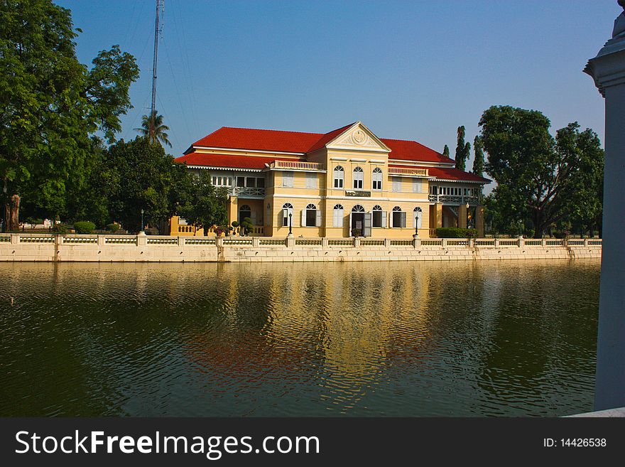 Refection of castle on water in old grand palace of King Rama the fifth in Thailand