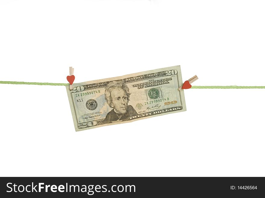 Twenty dollars hang on the rope with pegs. Isolated on white background. Twenty dollars hang on the rope with pegs. Isolated on white background