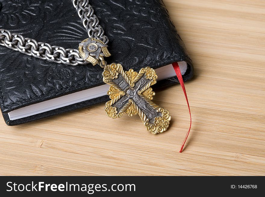 Bible and goold cross with silver chain. Bible and goold cross with silver chain