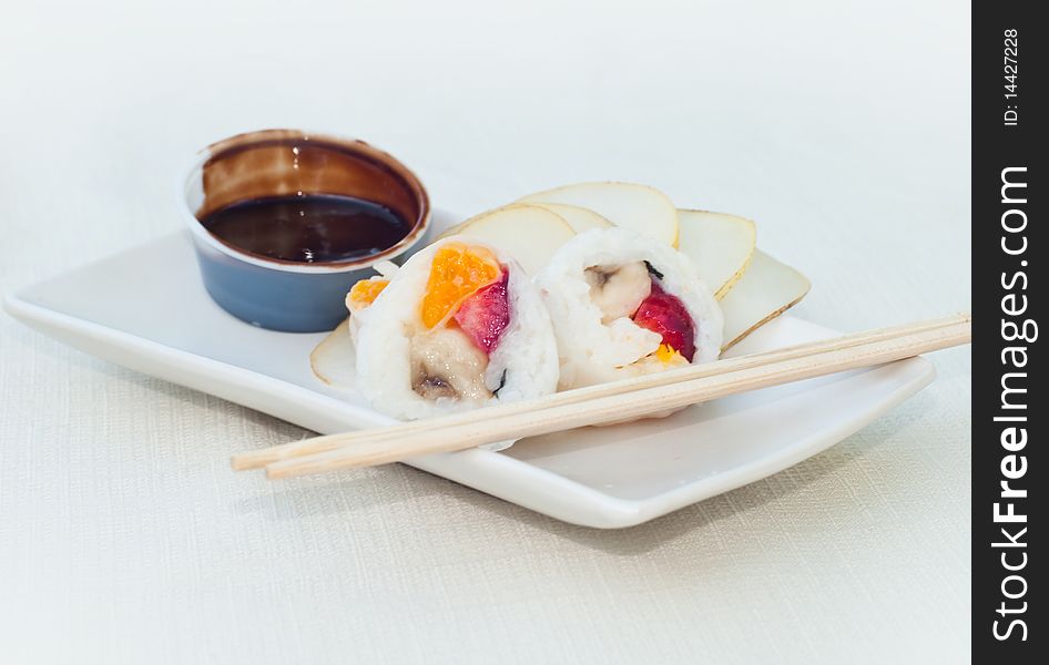 Delicious fruit sushis with chocolate sauce. Delicious fruit sushis with chocolate sauce
