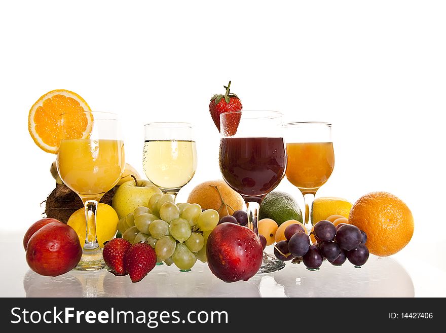 Various fruit cocktails surrounded by fresh fruit