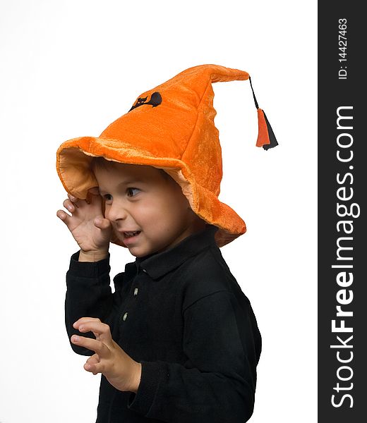 Toddler in Halloween hat tryes to scare somebody. Toddler in Halloween hat tryes to scare somebody