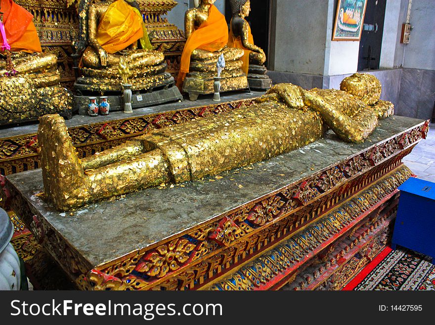 Sleeping Buddha laid face up decorate with golden sheets in Thailand