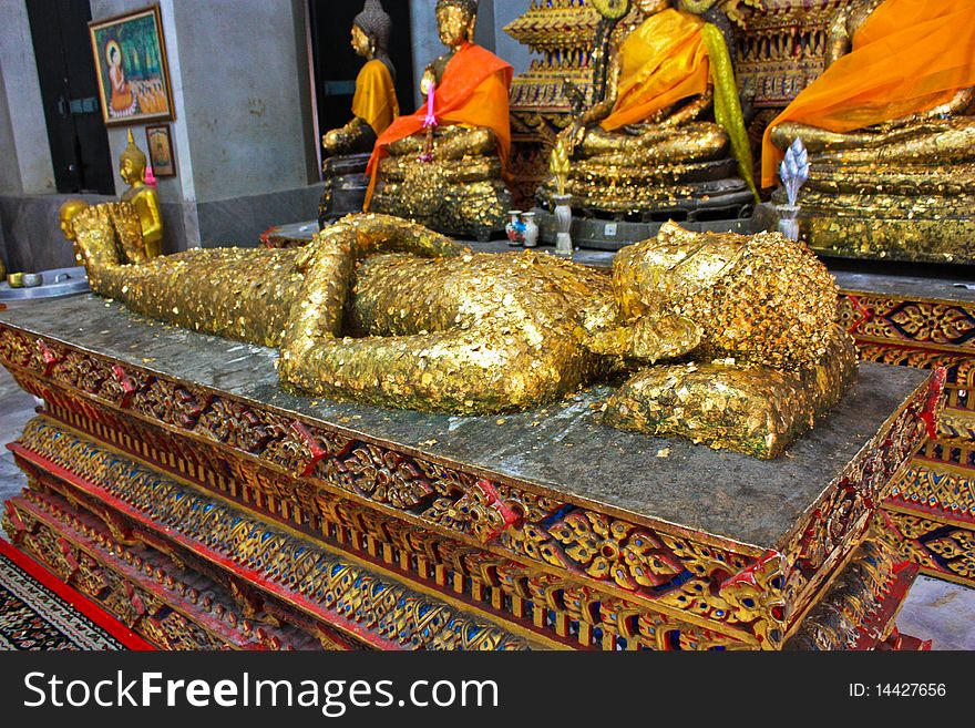 Sleeping Buddha laid face up decorate with golden sheets in Thailand