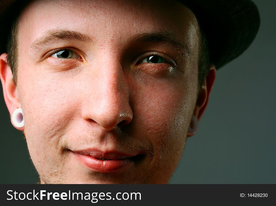 Close-up of a young man in hat