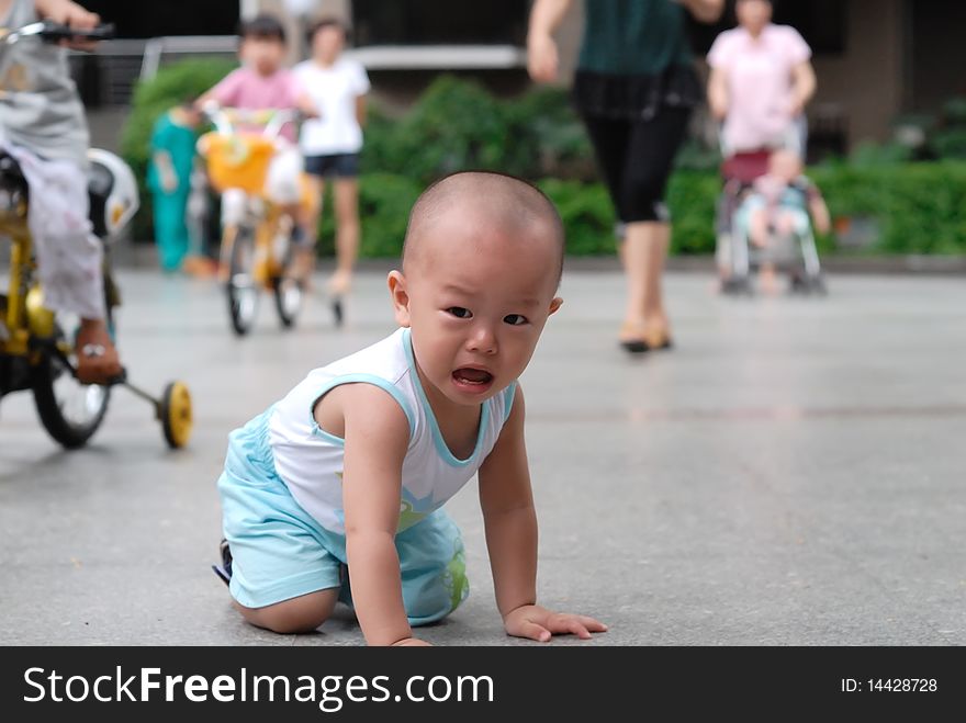 It is a cute chinese baby, he is crying in the outdoor. It is a cute chinese baby, he is crying in the outdoor.