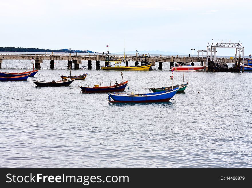 Row boats are mooring in the sea near the beach at Rayong, Thailand. Row boats are mooring in the sea near the beach at Rayong, Thailand.