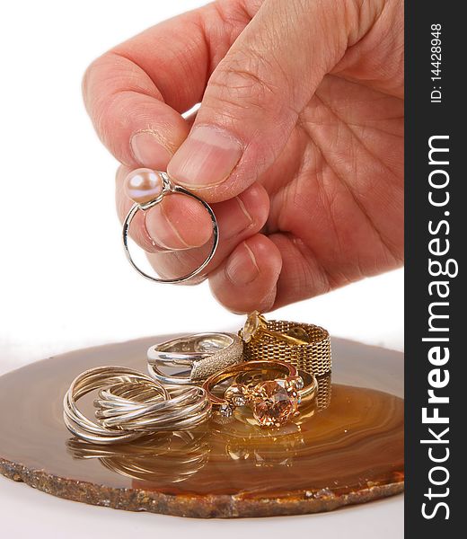 Hand holding a ring. Close up on white background