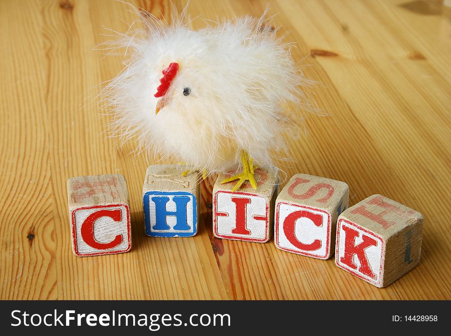 Wooden blocks spelling 'chick' with chicken. Wooden blocks spelling 'chick' with chicken