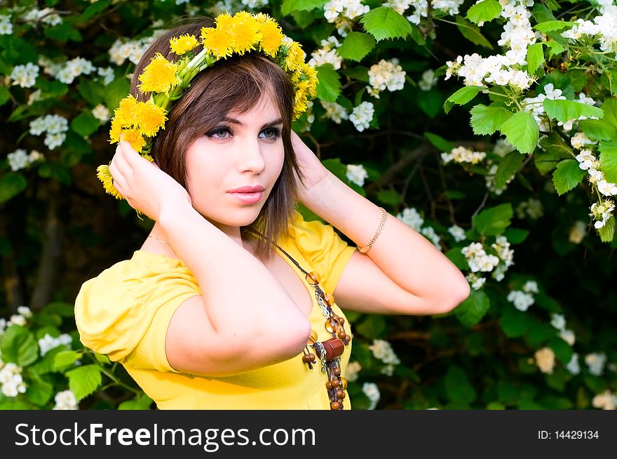 Portrait of young woman in dandelion garland. Portrait of young woman in dandelion garland