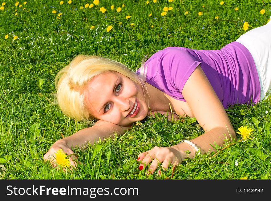 Pretty young smiling woman on the meadow. Pretty young smiling woman on the meadow