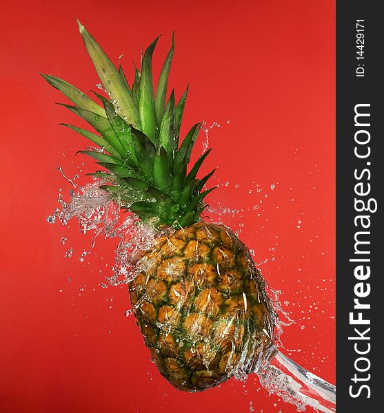 Splash in water with pineapple