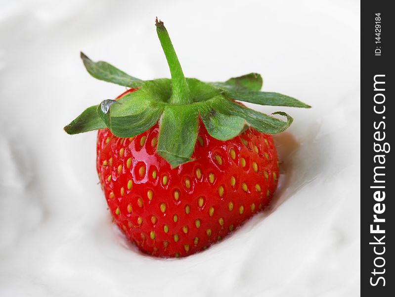 Juicy berry of a strawberry in sour cream