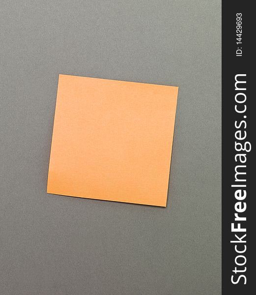 Orange Adhesive Note on grey background. Orange Adhesive Note on grey background