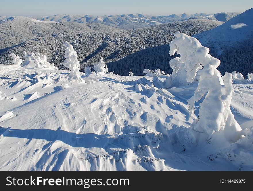 Winter white hillside in a landscape with the distant plan. Winter white hillside in a landscape with the distant plan.