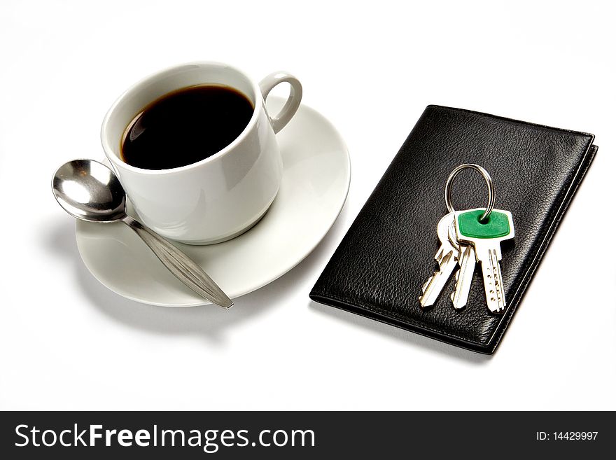 A cup of coffee, a wallet, a bunch of keys