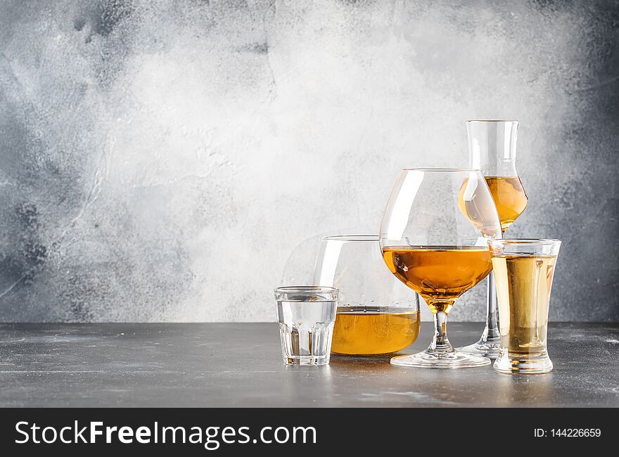 Set of hard strong alcoholic drinks and spirits in glasses in assortment: vodka, cognac, tequila, brandy and whiskey, grappa