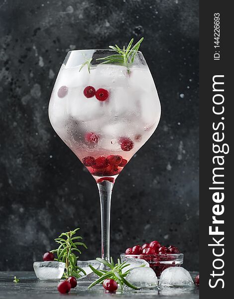 Cranberry Cocktail With Ice, Fresh Rosemary And Red Berries In Big Wine Glass, Bar Tools, Gray Bar Counter Background, Copy Space