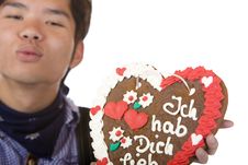 Man Holds Gingerbread Heart And Give Kiss Royalty Free Stock Photography