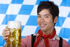 Smiling Asian Holds Oktoberfest Beer Stein (Mass) Stock Images Smiling Asian Holds Oktoberfest Beer Stein (Mass) Stock Images
