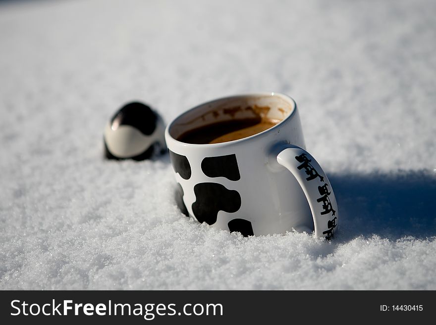 Egg and a cup of coffee in the snow. Egg and a cup of coffee in the snow.