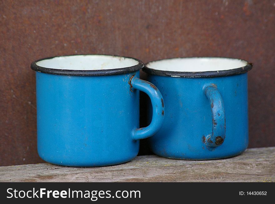 two old and rusty mugs
