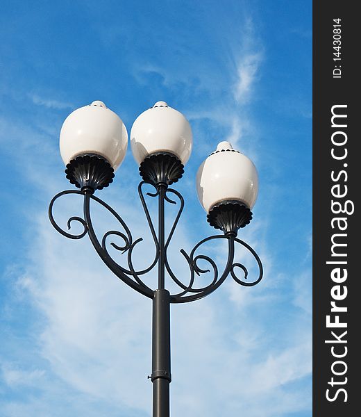 A classic street light against cloudy sky