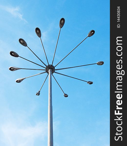 A street light in urban area, against a polarized blue sky.