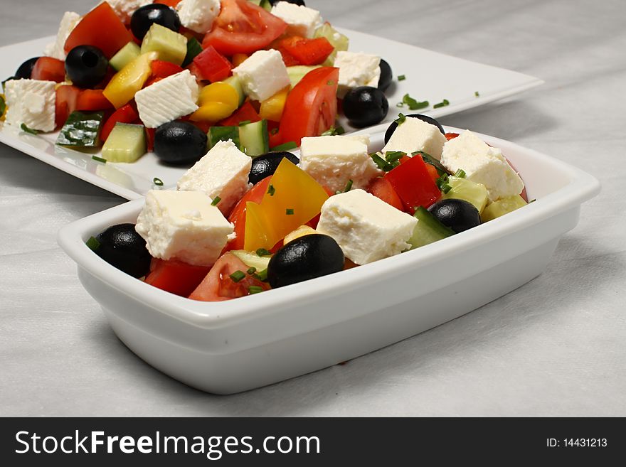 Detail of small salad dish in front of the salad plate. Detail of small salad dish in front of the salad plate