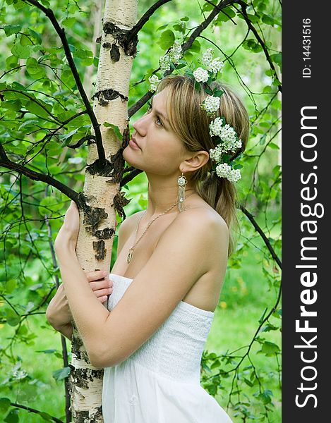 Young woman embraces   birch